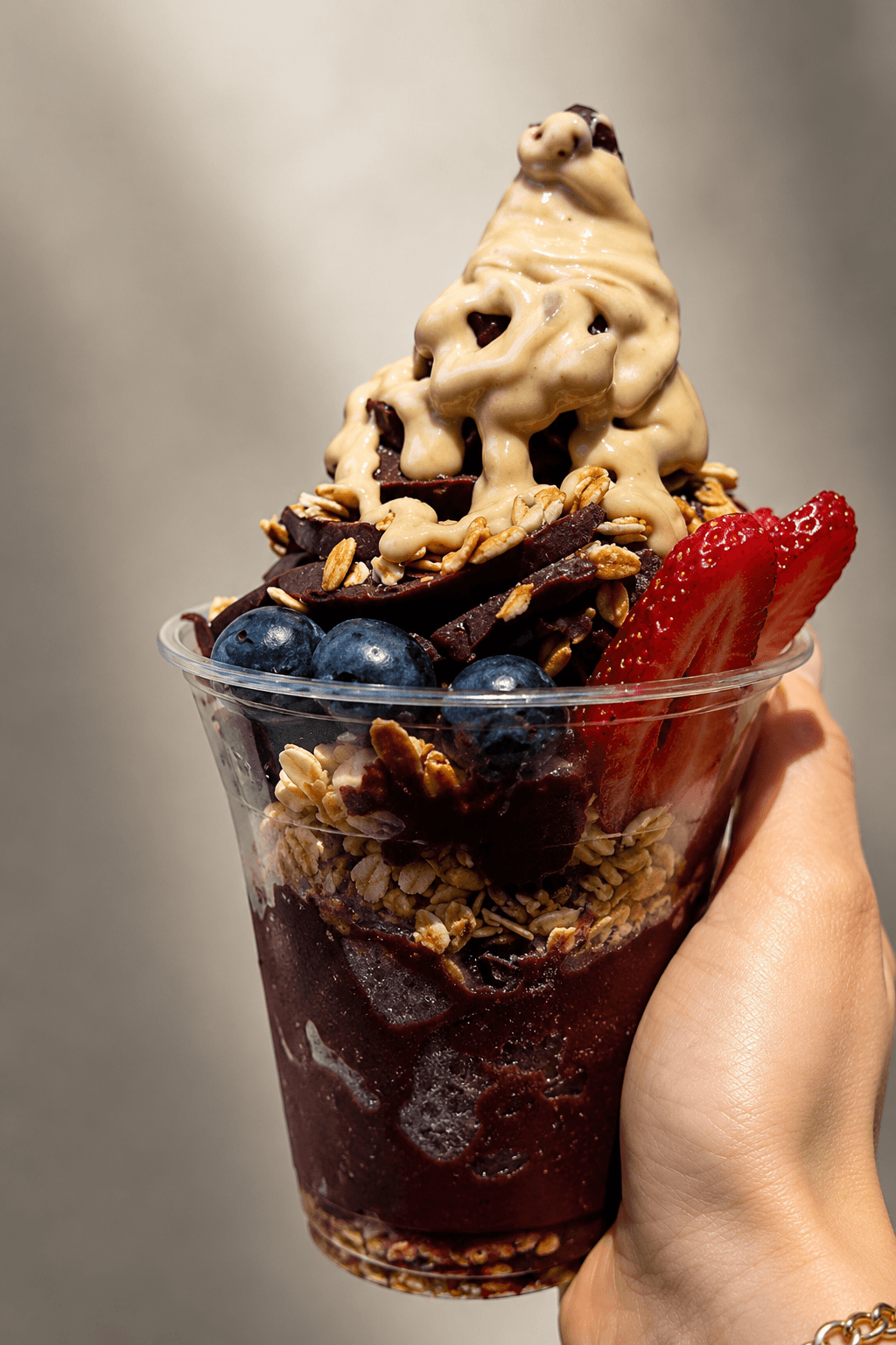 A Nabil's açaí bowl topped with strawberries, banana and chocolate drizzle