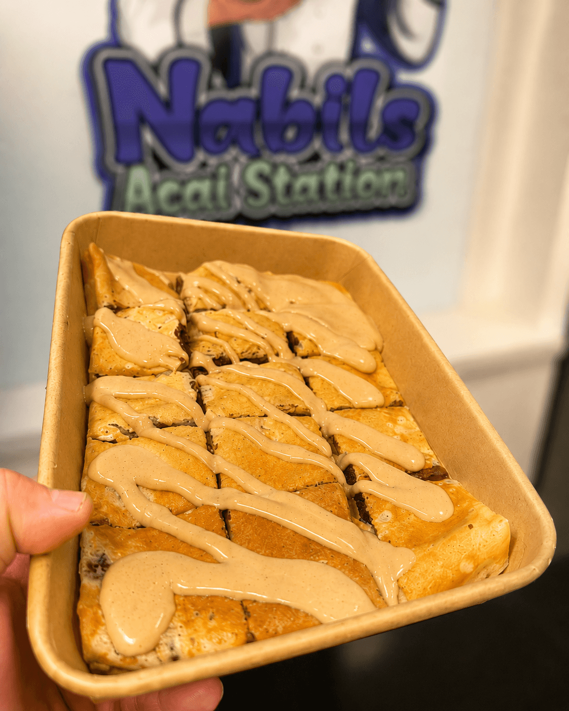 A classic Nabil's crêpe with strawberries, banana and sauce