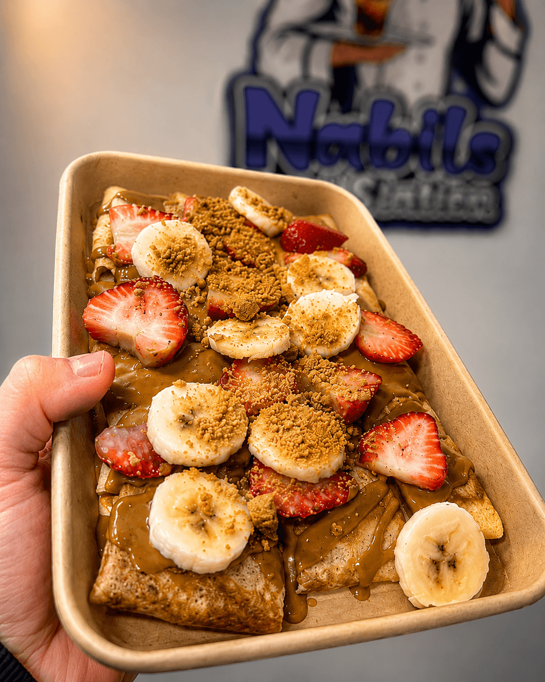 A Nabil's signature crepe finished with strawberries and chocolate