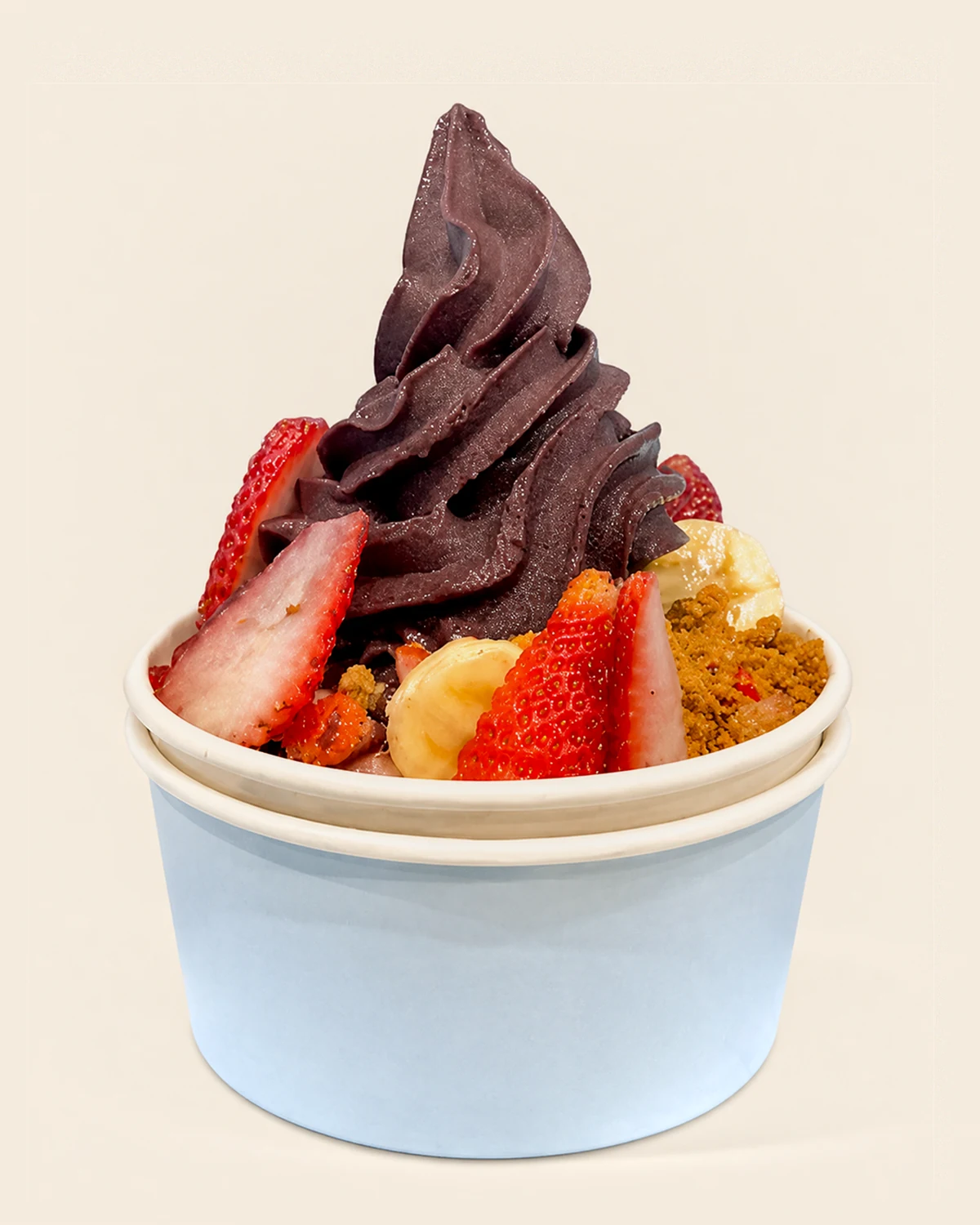 A Nabil's açaí swirl coated in dark chocolate, with strawberries, banana and golden crumble around the base