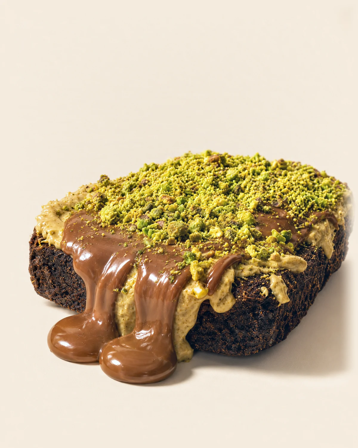 A Nabil's Dubai choc brownie with milk chocolate drizzle and crushed pistachio