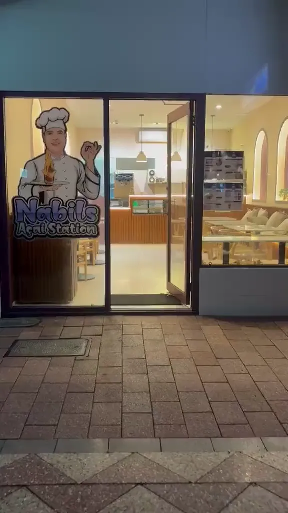 Walking in to Nabil's Açaí Station in Mount Lawley at night — through the front door, past the terrazzo floor and timber counter.